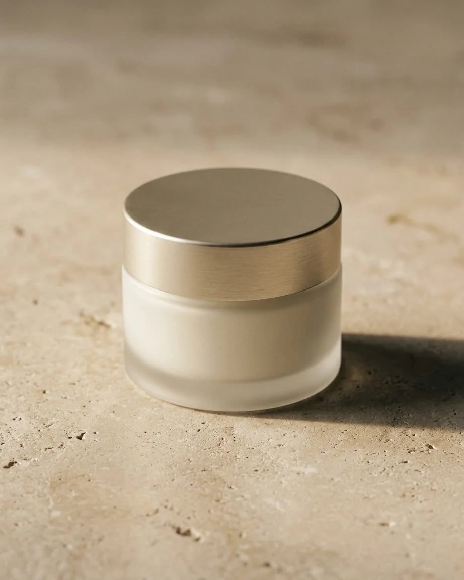 Composición editorial de un envase cosmético sin marca sobre piedra